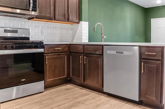 a kitchen with granite countertop a sink and a stove top oven