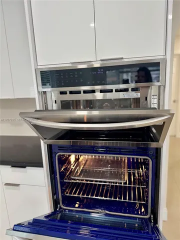 a stove top oven sitting inside of a kitchen