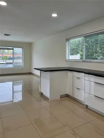 a view of a livingroom with an empty space and a window