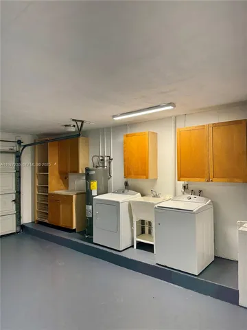 a view of a kitchen with cabinets and white appliances