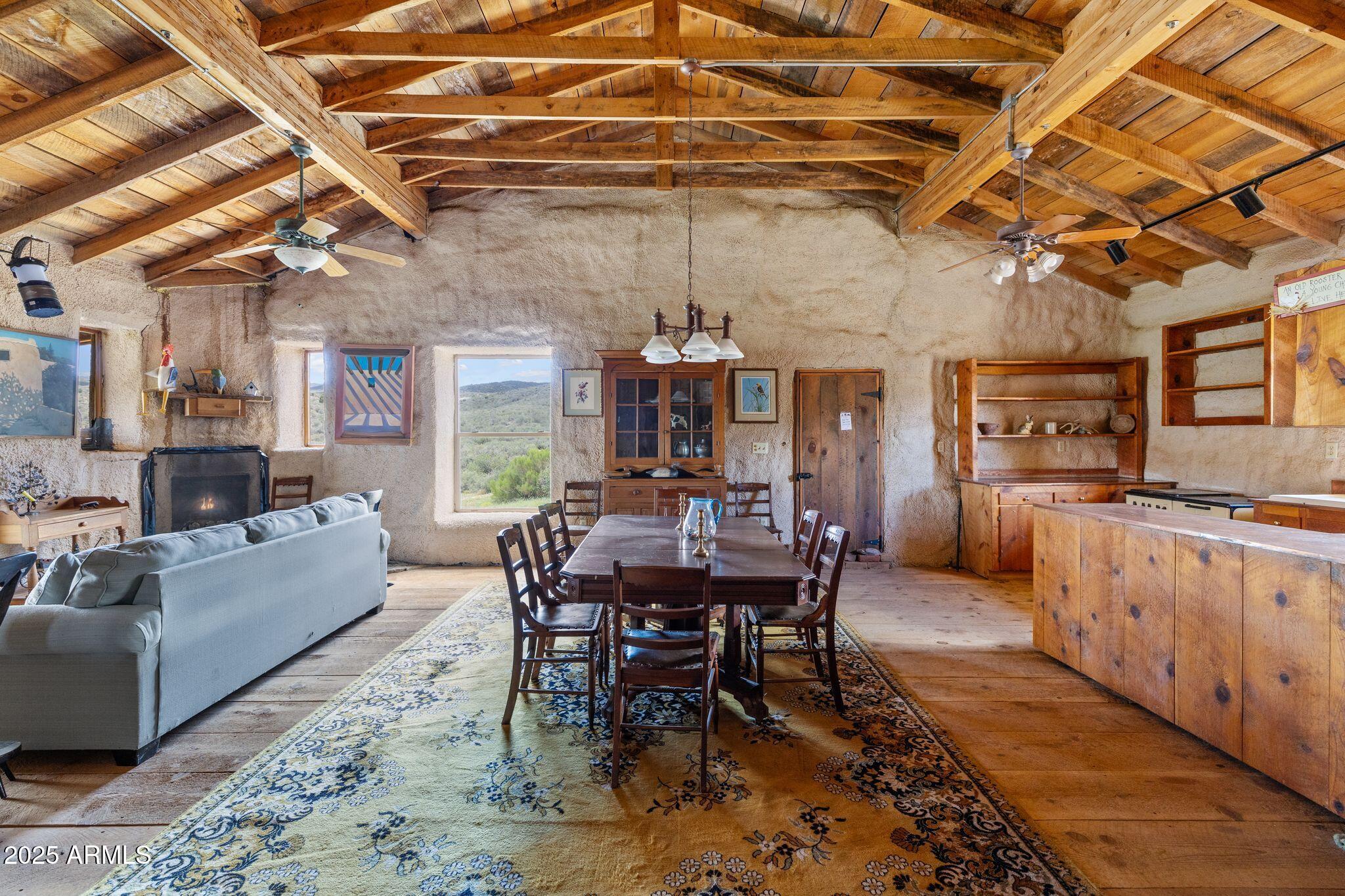 9955 East Iron King Road Mayer, AZ 86333 - Photo 10 of 41 a view of a dining room with furniture window and wooden floor