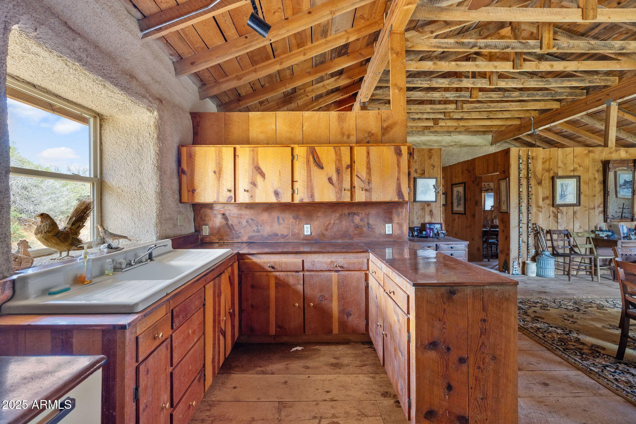 9955 East Iron King Road Mayer, AZ 86333 - Photo 15 of 41 a kitchen with a sink a stove and cabinets