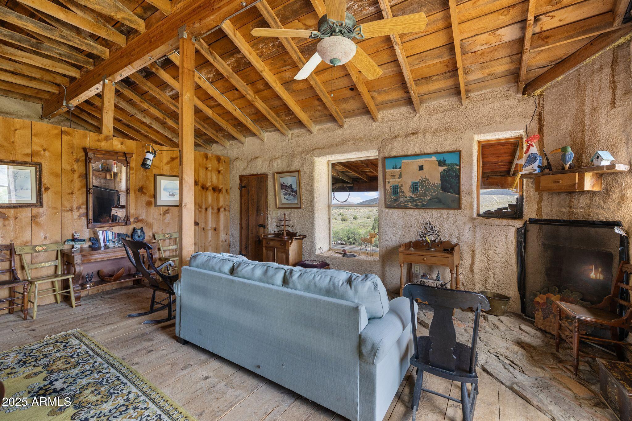 9955 East Iron King Road Mayer, AZ 86333 - Photo 9 of 41 a living room with furniture and a flat screen tv