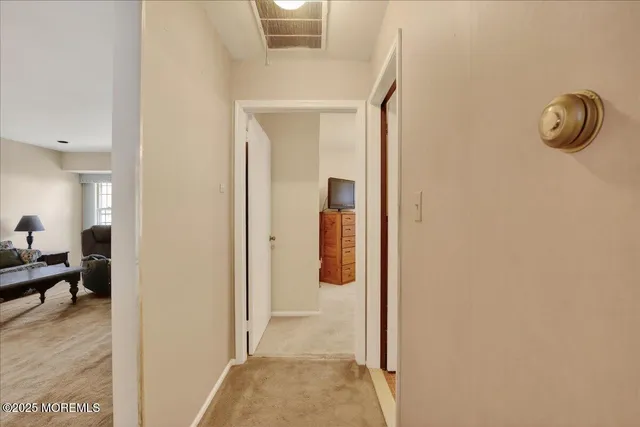 a view of hallway with livingroom and furniture