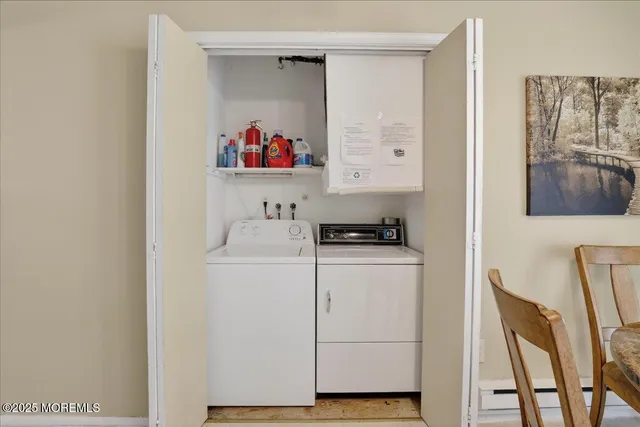 a storage room with wooden floor washer and dryer