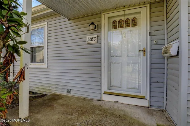 a view of a house with a door and wooden fence