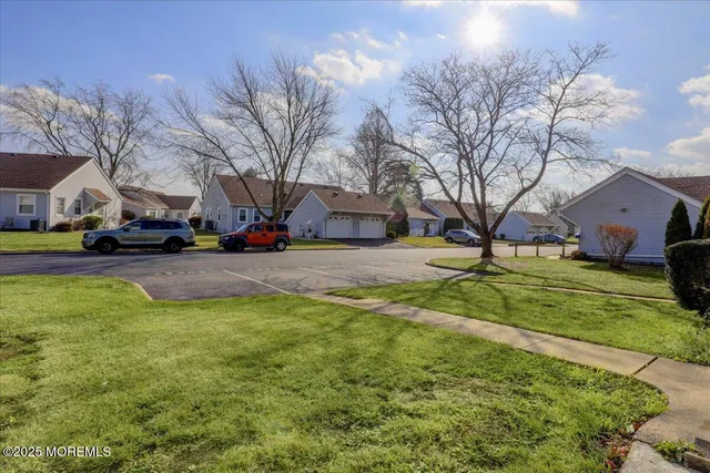 a view of a yard with a house in the background