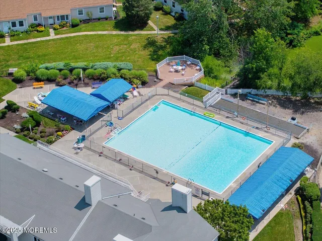 an aerial view of a tennis ground and a swimming pool