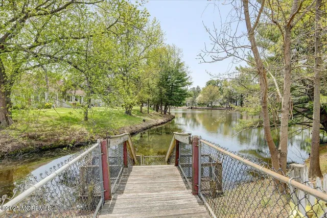 a balcony with wooden floor and lake view