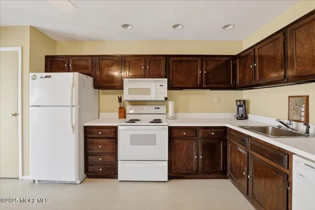 a kitchen with a white stove top oven and refrigerator