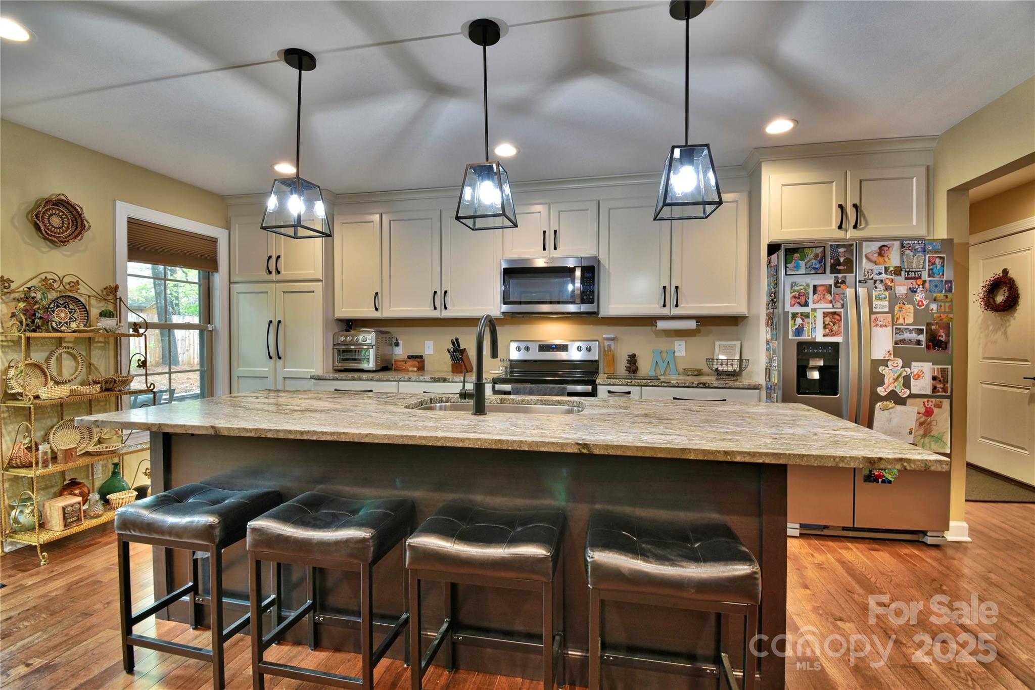 482 Old Camp Road Denton, NC 27239 - Photo 14 of 48 a kitchen with stainless steel appliances kitchen island a chandelier and refrigerator