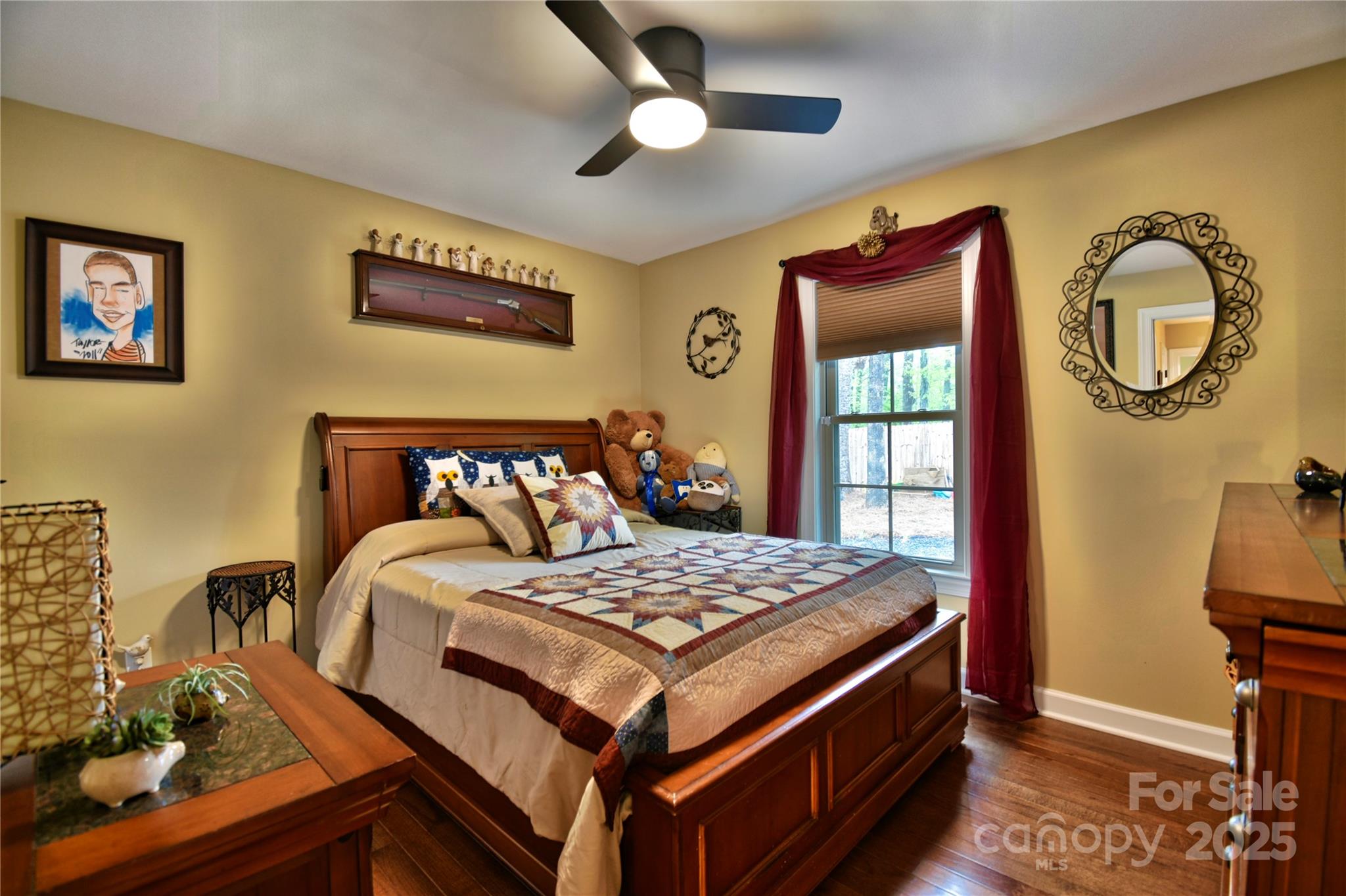 482 Old Camp Road Denton, NC 27239 - Photo 39 of 48 a bedroom with a bed and a chandelier