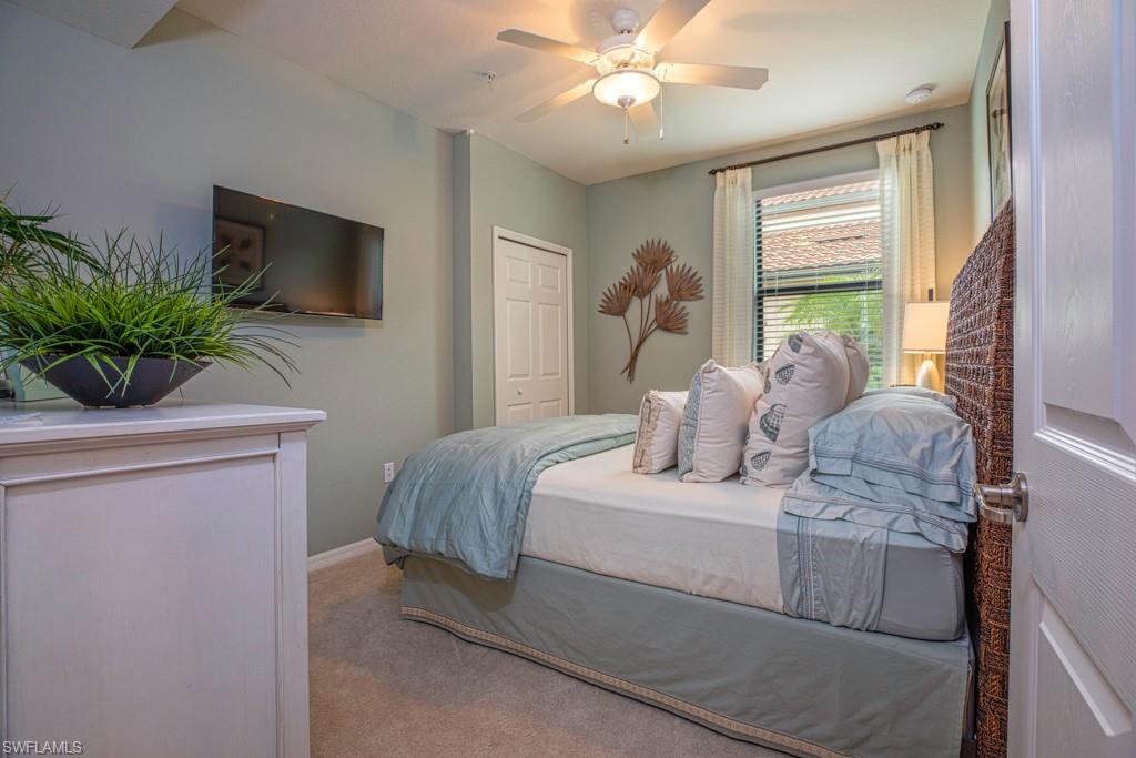 3161 Aviamar Circle, Unit 101 Naples, FL 34114 - Photo 11 of 32 a bedroom with a large bed and a window
