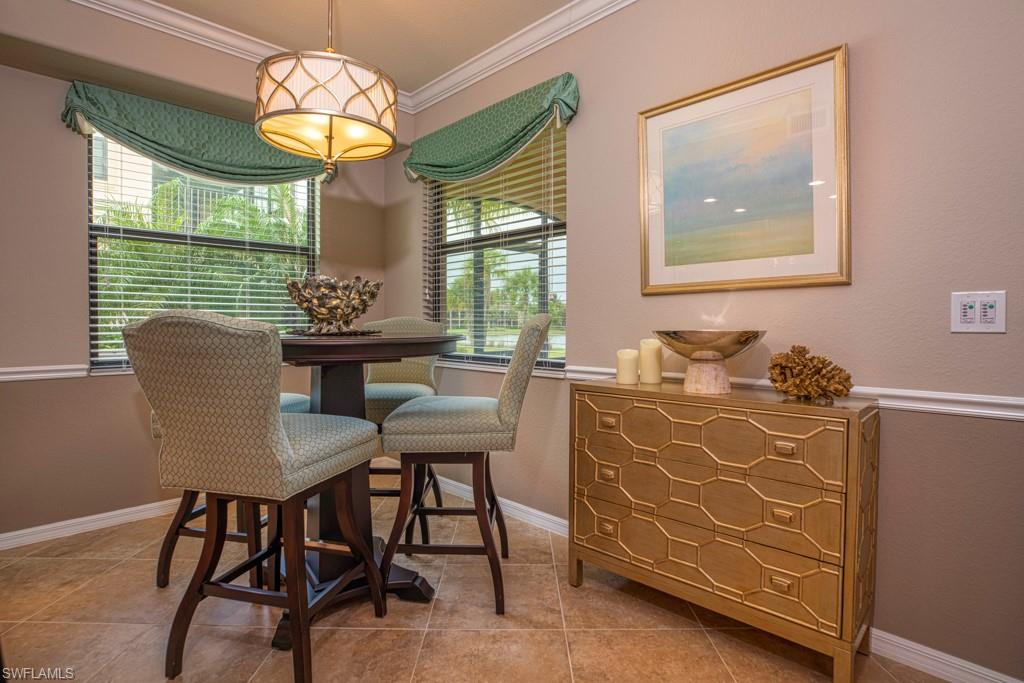 3161 Aviamar Circle, Unit 101 Naples, FL 34114 - Photo 14 of 32 a view of a dining room with furniture a chandelier and window