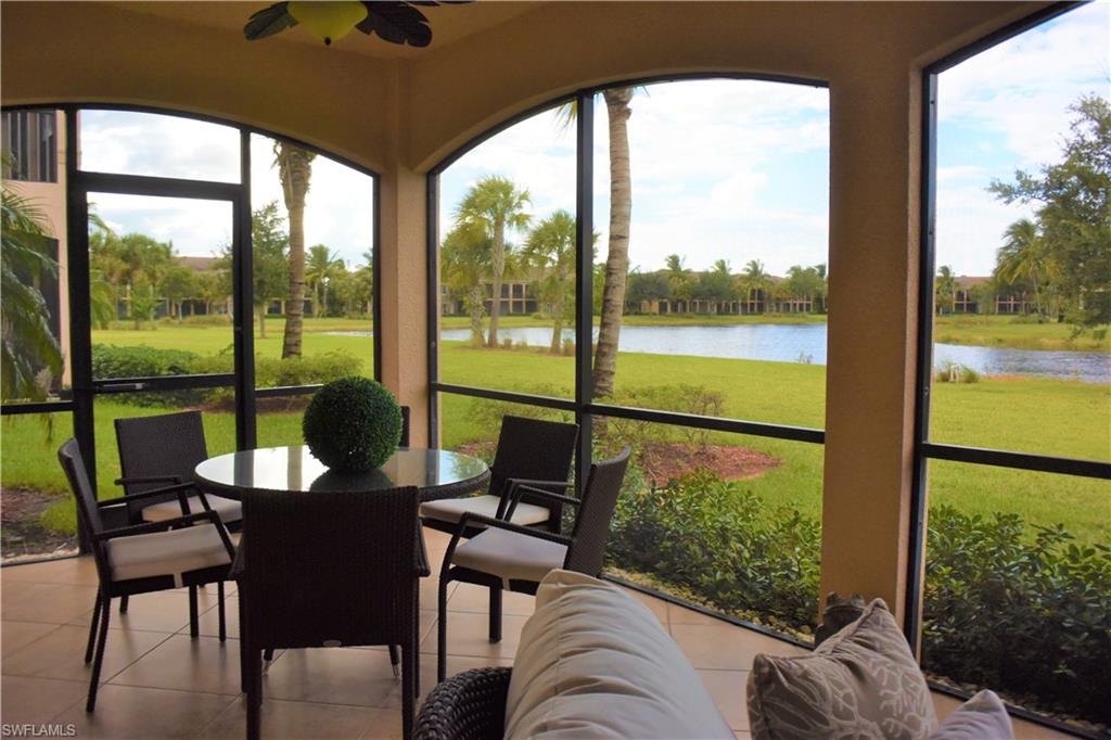 3161 Aviamar Circle, Unit 101 Naples, FL 34114 - Photo 20 of 32 a living room with furniture and floor to ceiling windows