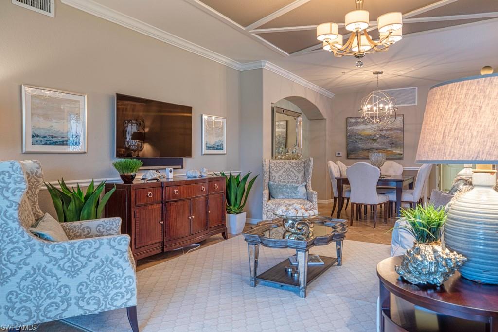 3161 Aviamar Circle, Unit 101 Naples, FL 34114 - Photo 2 of 32 a living room with furniture potted plant and a flat screen tv