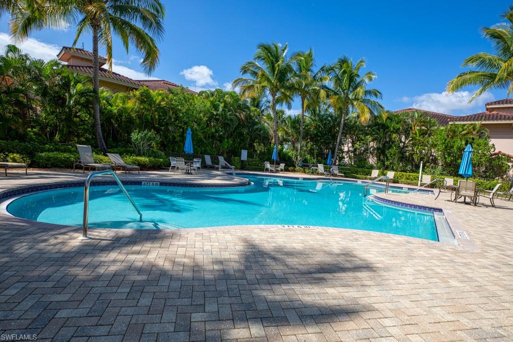 3161 Aviamar Circle, Unit 101 Naples, FL 34114 - Photo 21 of 32 a view of a swimming pool with a patio