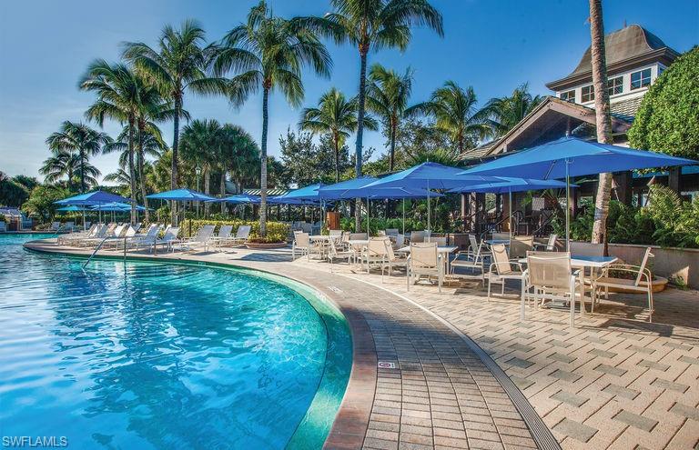 3161 Aviamar Circle, Unit 101 Naples, FL 34114 - Photo 26 of 32 a view of swimming pool with outdoor seating and patio