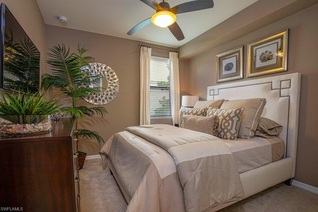 3161 Aviamar Circle, Unit 101 Naples, FL 34114 - Photo 9 of 32 a bedroom with a bed and a potted plant