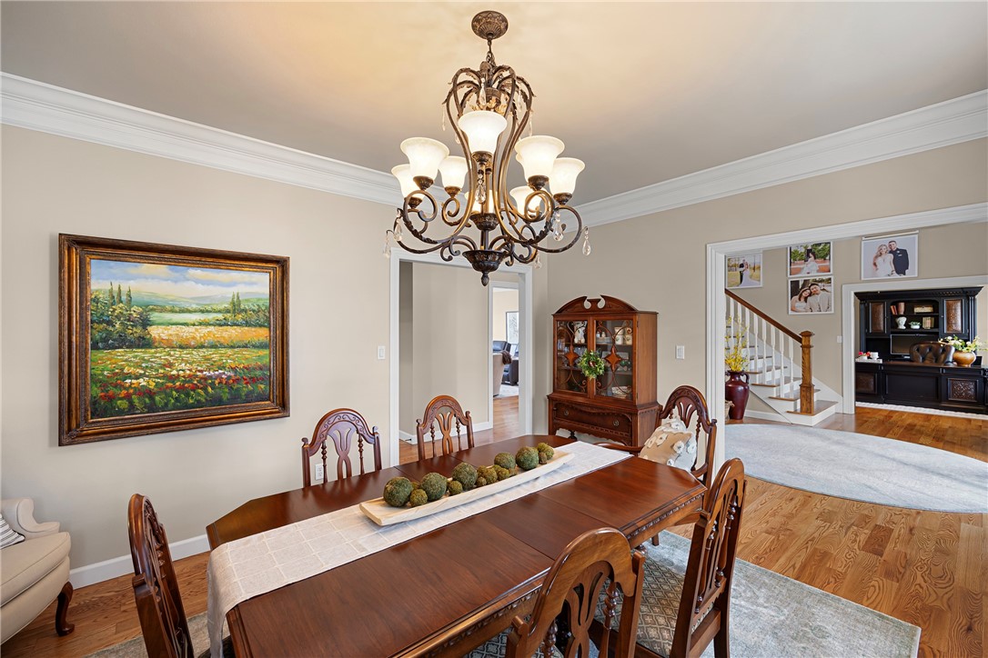 788 Cliff Road Russellville, AR 72802 - Photo 17 of 60 Dining space with wood finished floors, a chandelier, and ornamental molding