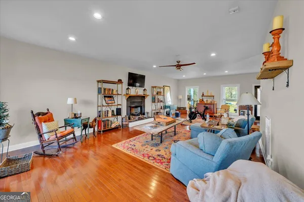 a living room with furniture kitchen view and a fireplace
