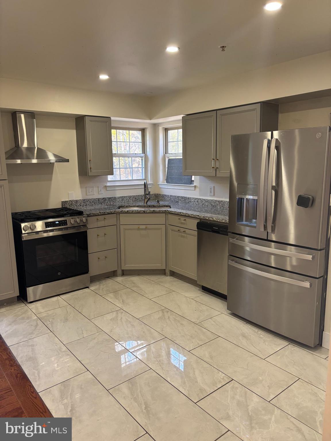 6610 Central Avenue Capitol Heights, MD 20743 - Photo 3 of 9 a kitchen with stainless steel appliances granite countertop a sink and a stove