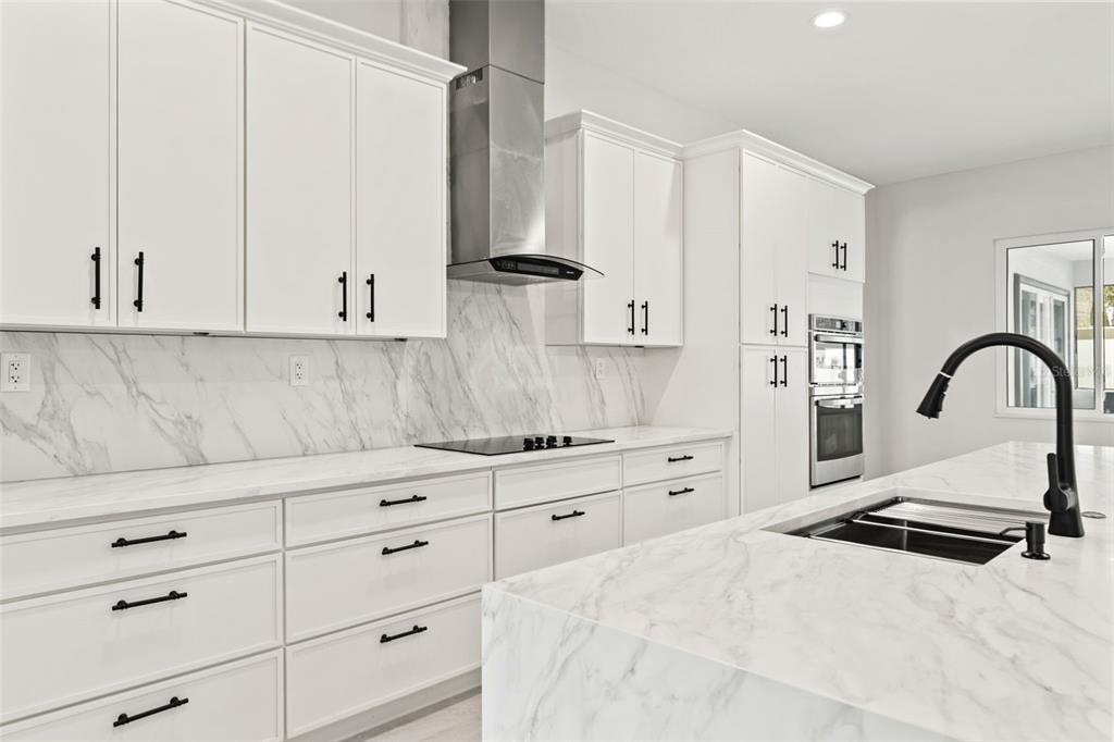 10700 Pontofino Circle Trinity, FL 34655 - Photo 30 of 99 a kitchen with granite countertop white cabinets and white appliances