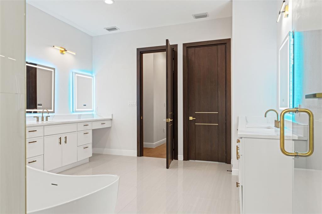 10700 Pontofino Circle Trinity, FL 34655 - Photo 48 of 99 a bathroom with a double vanity sink a mirror and a bathtub