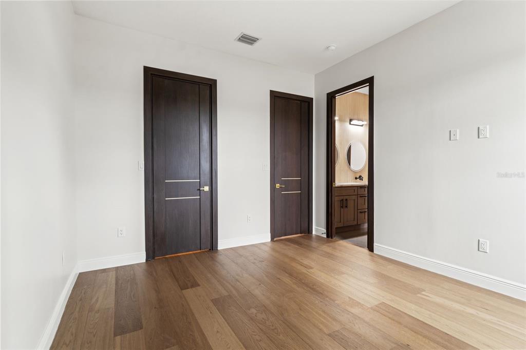 10700 Pontofino Circle Trinity, FL 34655 - Photo 62 of 99 a view of an empty room with wooden floor & closet