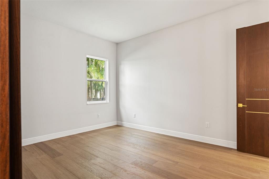 10700 Pontofino Circle Trinity, FL 34655 - Photo 70 of 99 an empty room with wooden floor and windows