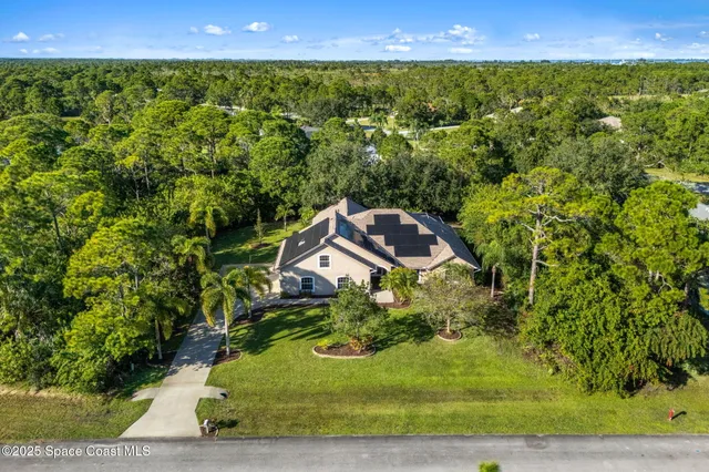 a living room with patio furniture and a large window