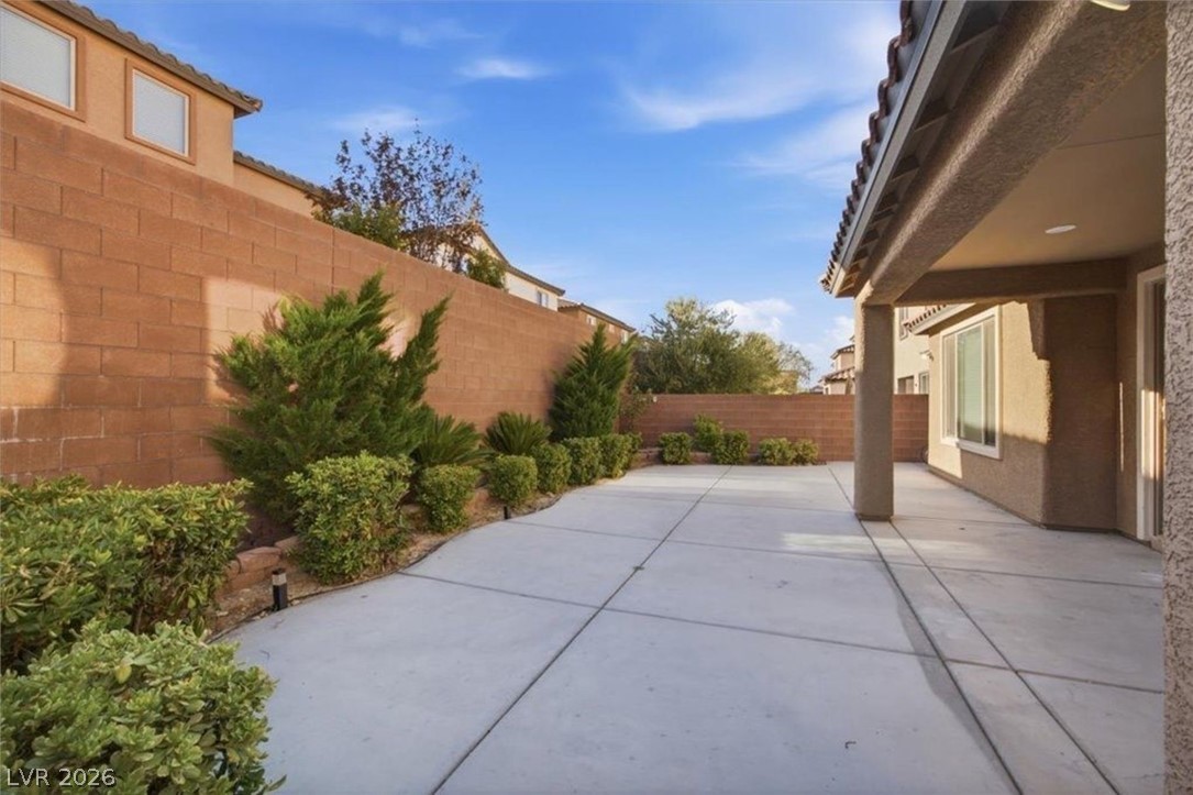 11009 Prairie Grove Road Las Vegas, NV 89179 - Photo 38 of 49 A spacious concrete patio awaits, offering ample room for outdoor enjoyment and relaxation.
