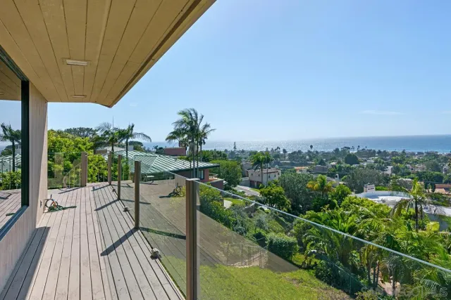 a bathroom with a granite countertop sink a toilet a mirror and shower