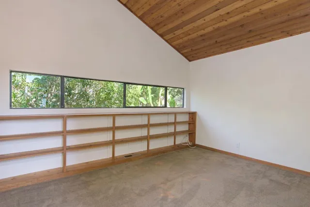 a bedroom with a bed and a refrigerator