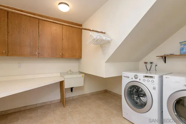 a view of a kitchen with a sink and a refrigerator
