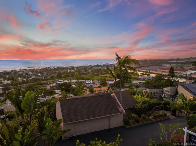 a view of an empty room with a fireplace and a floor to ceiling window