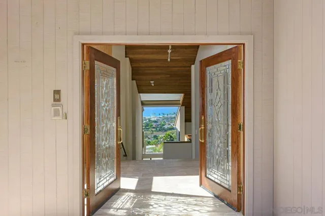 a view of a balcony with wooden floor and fence