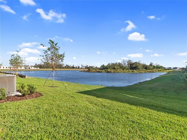 a view of a lake with houses in the back
