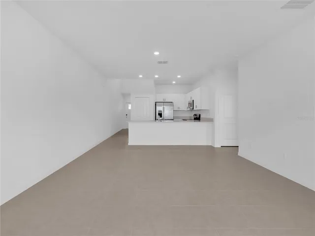 a view of a kitchen with a sink and dishwasher a microwave oven with wooden floor
