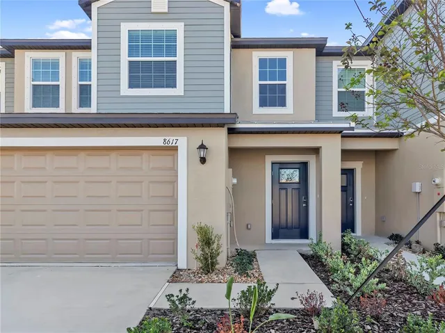 front view of a brick house with a large windows