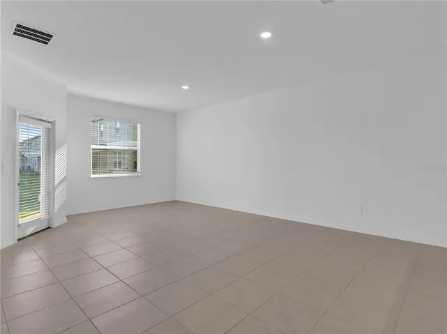 an empty room with windows and closet