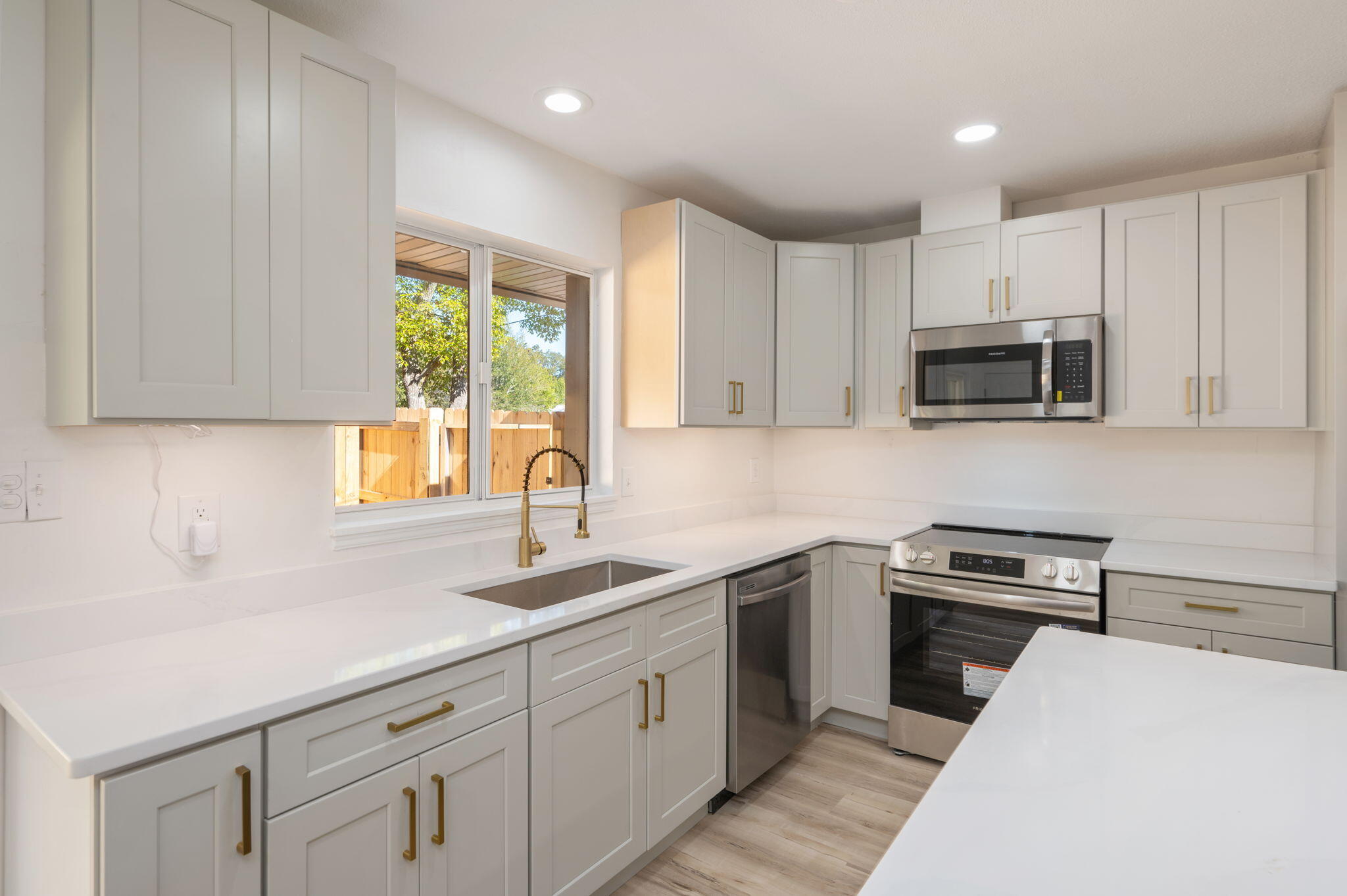 118 Ferry Road Northeast Fort Walton Beach, FL 32548 - Photo 15 of 51 a kitchen with cabinets appliances a sink and a window