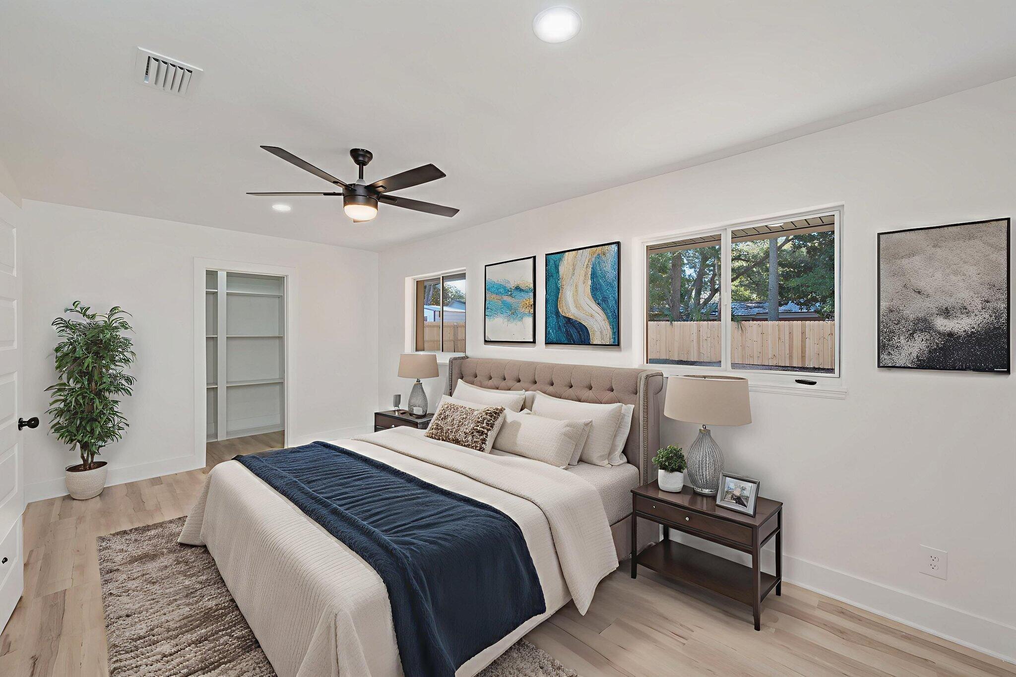 118 Ferry Road Northeast Fort Walton Beach, FL 32548 - Photo 19 of 51 a bedroom with a large bed and a chandelier