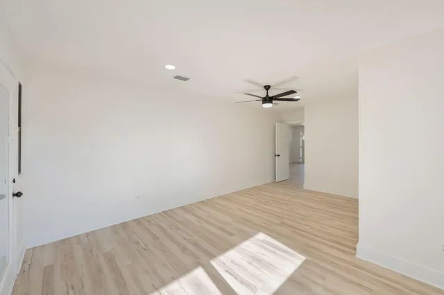 a view of a yard in front of a house with large trees