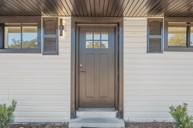 a view of empty room with wooden floor and fireplace