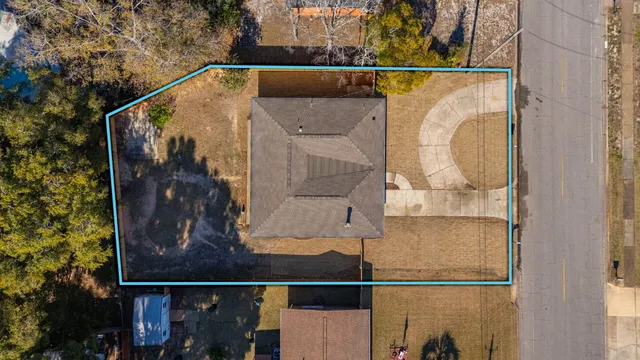 an aerial view of a house with a yard