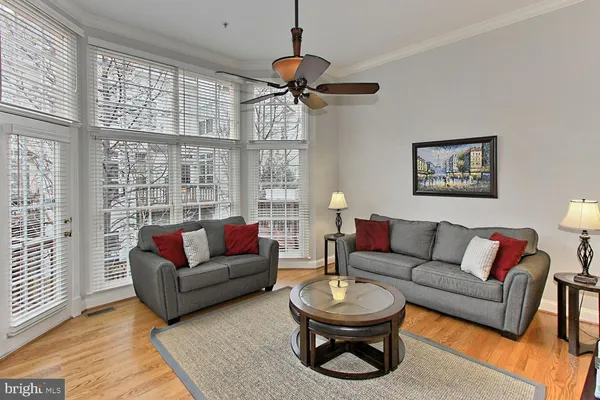 a living room with furniture a rug and a large window