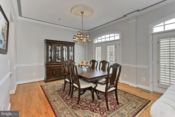 a dining room with furniture a rug and wooden floor