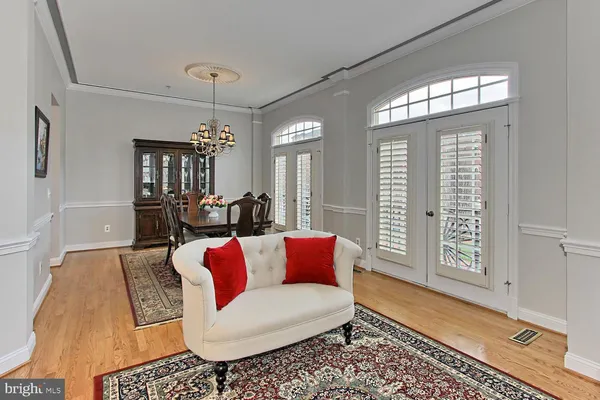 a living room with furniture and a chandelier