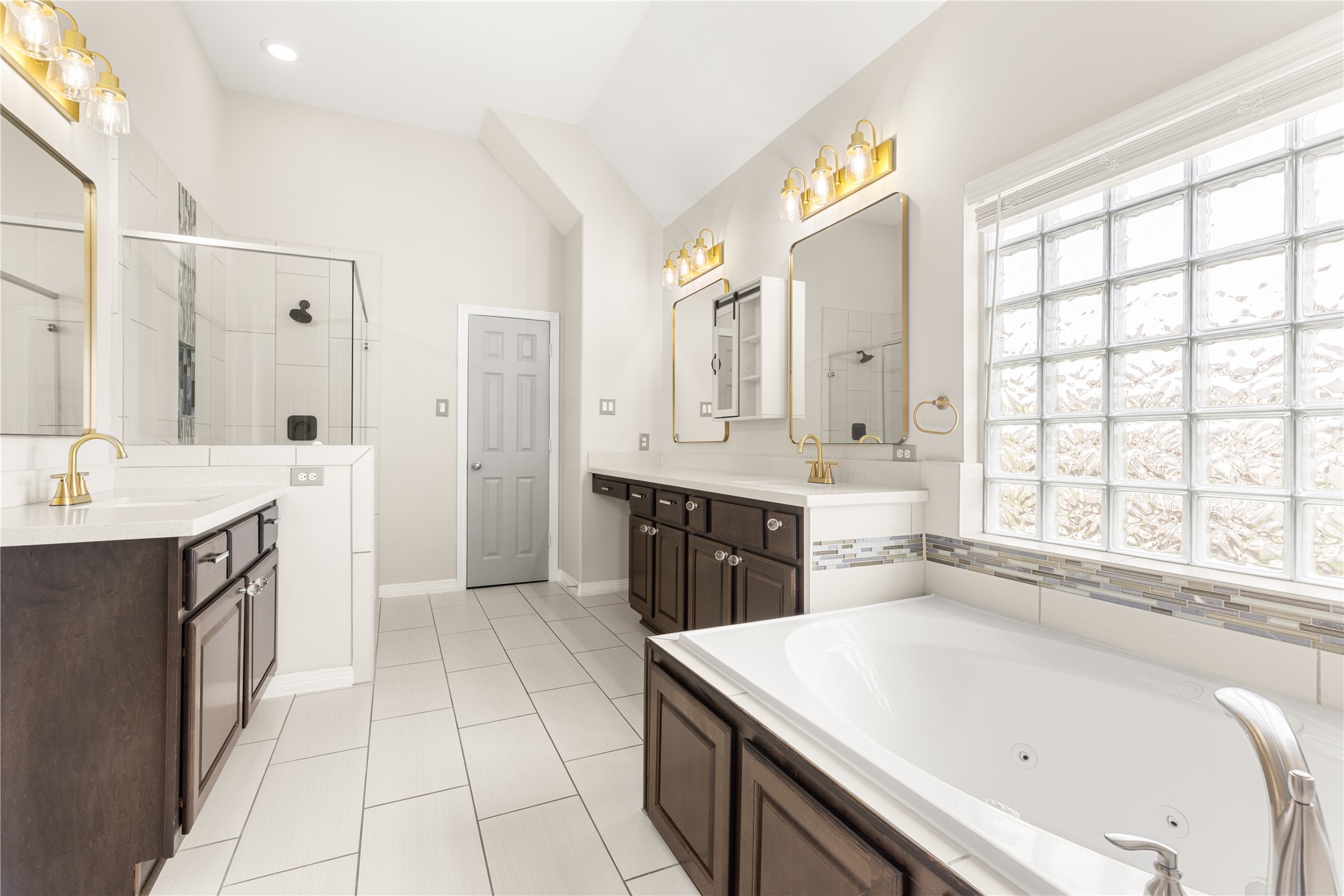 10215 Spring Shadows Park Circle Houston, TX 77080 - Photo 24 of 44 Updated primary bathroom with two sinks/vanity area.